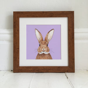 Bunny illustration on a purple background in light wood frame